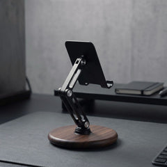 Super wooden stand supporting a smart phone, placed against a shelf with decorative items | Cyber Vintage