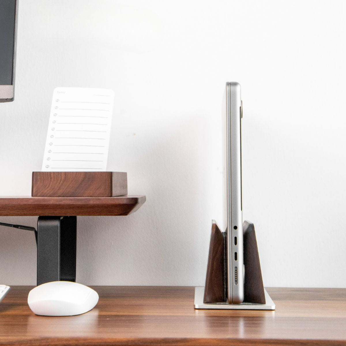 Super Wood Vertical Stand holding a laptop upright in a compact desk setup to save space and keep the workspace organized | Cyber Vintage