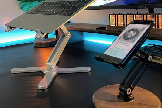 A laptop stand and a wooden phone stand on a desk