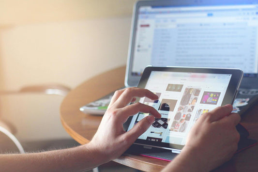 A person using a tablet with tablet stand
