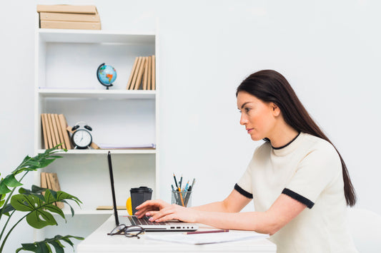 A lady seriously working at her desk