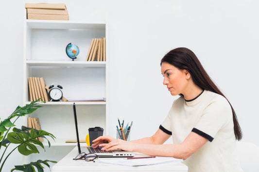 A lady seriously working at her desk