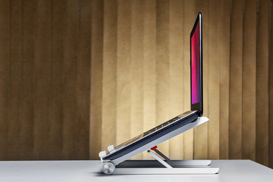 A laptop placed on a laptop stand for better ergonomics