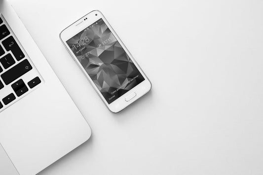 a top view of a laptop and a mobile without phone stand