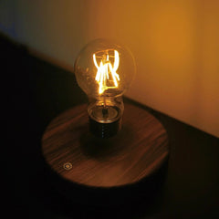 Magic Levitating Lamp Retro Bulb casting a soft glow on a dark wooden base | Cyber Vintage